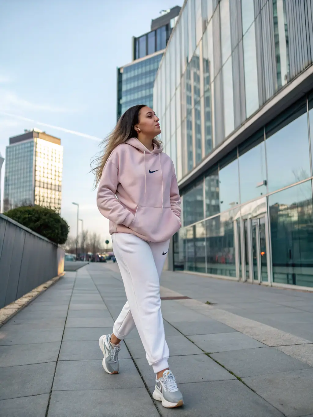 A person casually wearing Mostbet SportsWear activewear while walking in the city, showing style and comfort.